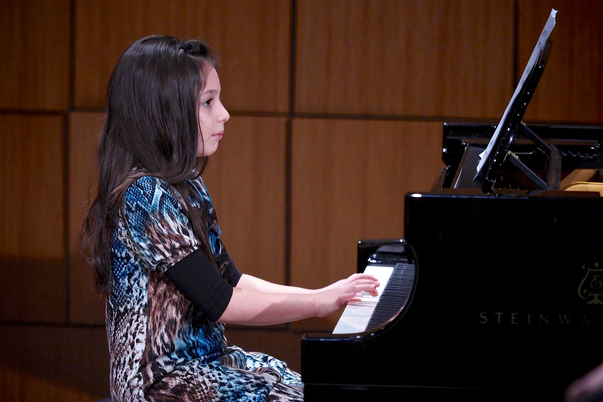 Student performing piano at recital