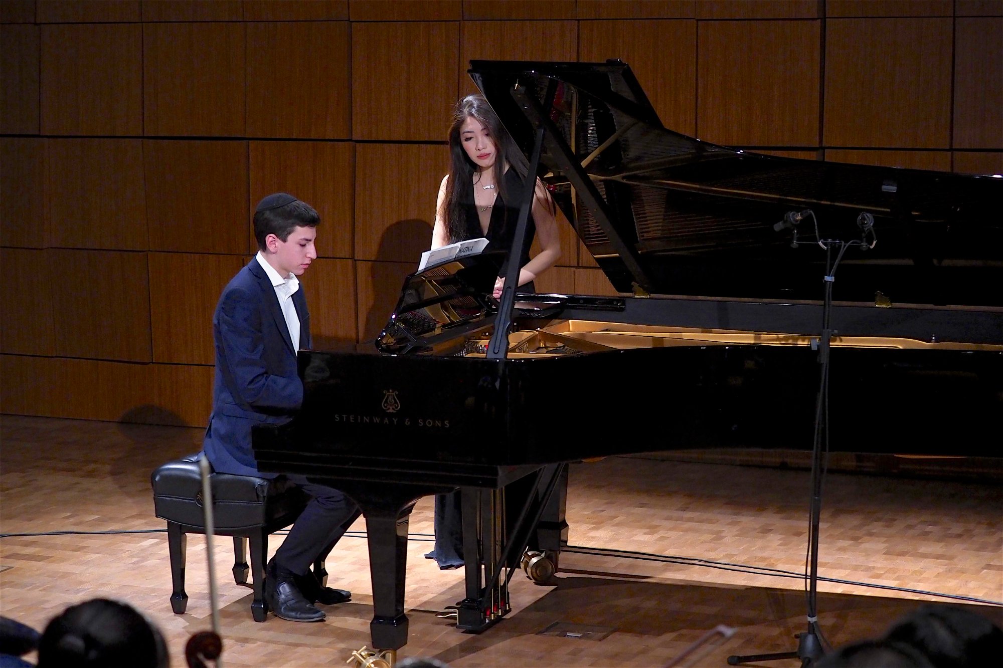 Older student performing at Steinway grand piano with Cristina