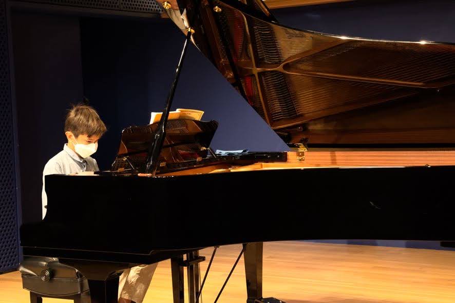 Student performing piano solo at recital 2021