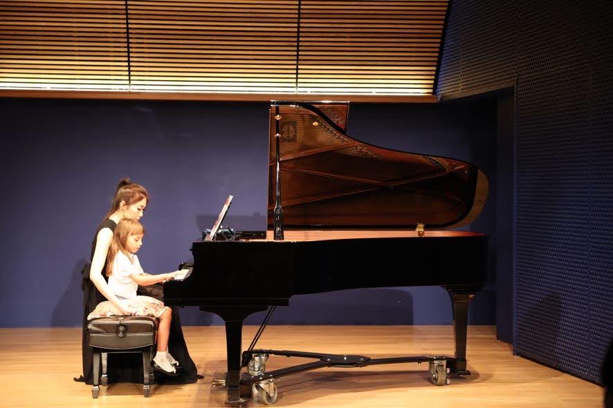 Cristina and student performing piano duet 2021