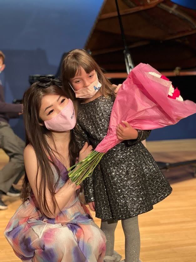 Cristina with student at Yamaha grand piano recital 2022