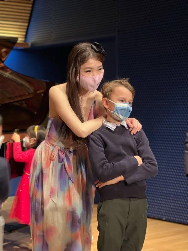 Cristina with student holding flowers at recital 2022
