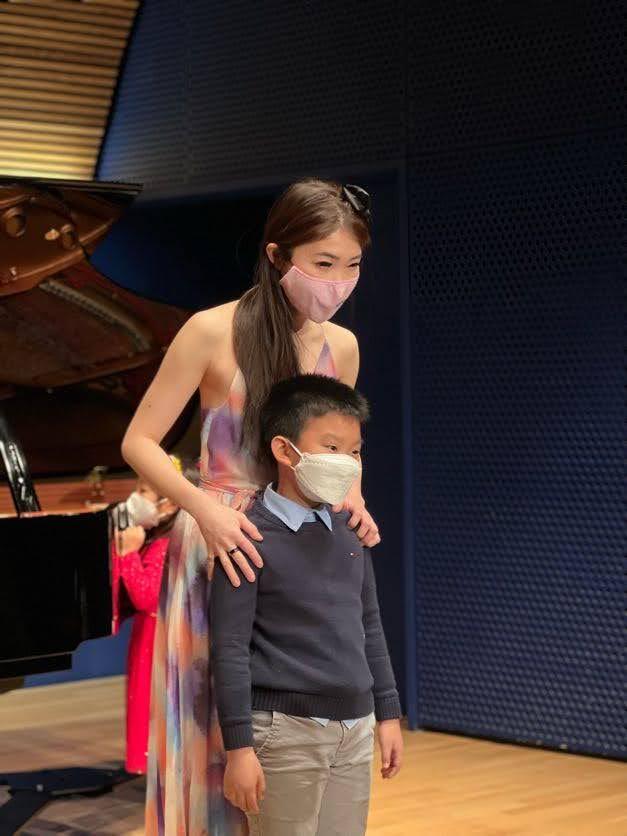 Cristina with students at grand piano recital 2022